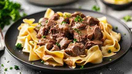 Wall Mural - Hearty european meal: delicious latvian beef stroganoff with ribbon noodles and chopped parsley garnish
