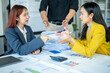 © Wasana - Two women are arguing over papers on a desk. One woman is pointing at a piece of paper and the other woman is looking at her