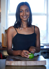 Sticker - Woman, portrait and cutting fruit in kitchen for diet, smile and healthy eating in Sri Lanka. Female person, lime and preparing for juice, smoothie and home for morning routine or weight loss