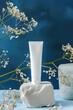 Elegant Cosmetic Tube on Pedestal with Spring Flowers and Pastel Background