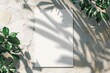 Serene Shadows: Blank Paper Canvas Surrounded by Natural Leaf Silhouettes
