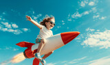 Fototapeta Zachód słońca - smiling cute little boy is riding a rocket in the sky