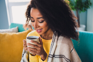 Wall Mural - Photo of lovely cute girl sitting on couch drinking coffee enjoying vacation cosy atmosphere indoors