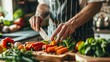 © Galib - A chef is chopping vegetables on a wooden cutting board. He is using a sharp knife to cut the vegetables into small pieces.