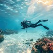 Scuba diver diving in the clear blue sea, swimming underwater with coral reefs and white sand bottom