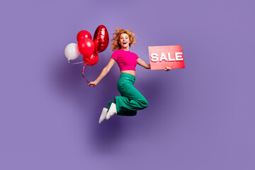 Wall Mural - Photo of cheerful glad nice woman wear trendy pink clothes hold poster proposition isolated on purple color background