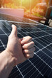 Thumb up on solar panel background