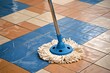 A detailed view of a mop in motion, efficiently cleaning a tiled floor, maintaining hygiene standards
