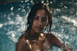 A detailed shot capturing the elegance of a bronzed Latina woman, slim yet curvaceous, emerging from the water with confidence in a bikini