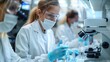 © Paworn - Scientists wearing protective gear work diligently in a modern laboratory.