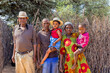 African village, large family standing parents and kids in front of the outdoors kitchen,