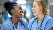 Two nurses sharing a laugh and conversation in a hospital setting. Concept Nursing, Workplace Interaction, Healthcare Communication, Laughter, Team Bonding