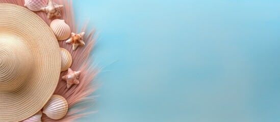 Poster - A top view of a color background with a gorgeous straw hat and seashells perfect for copy space image