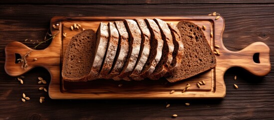 Poster - A beautiful arrangement of freshly baked sliced rye bread on a wooden cutting board captured from above The image has copy space for added versatility