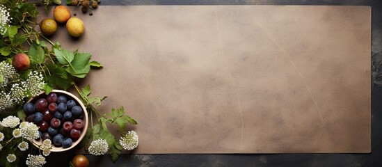 Aufkleber - A dark stone table with a sheet of brown paper for writing green gooseberries and blueberries a bouquet of field daisies and scissors create a background for creativity in this top view copy space im