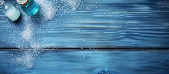 Poster - Wet old blue wood table with shampoo shower gel perfume and bath salt samples Copy space image