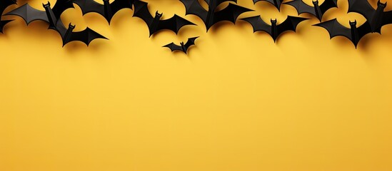 Poster - A top view image of a Halloween banner featuring black paper bats on a yellow and white background with a horizontal orientation and plenty of copy space