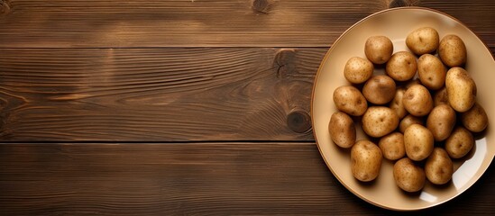 Aufkleber - A copy space image featuring a plate of uncooked potatoes is placed on a rustic wooden table
