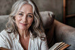 © Наталья Лазарева - Captivating image of a 60-year-old woman immersed in reading, her beauty timeless and radiant, her skin glowing with health, embodying elegance and sophistication in every glance