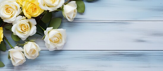 Fototapete - A white and yellow rose arrangement is beautifully displayed on a rustic blue wooden background creating a perfect copy space image for a message on a blank white card