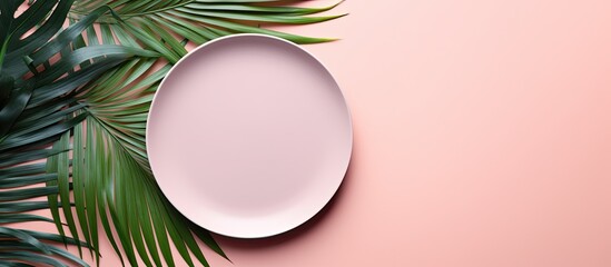 Poster - A minimalistic top down view of millennial pink paper background with an empty plate placeholder surrounded by vibrant green tropical palm leaves Perfect for your text or design ideas A visually appe
