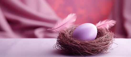 Fototapete - A brightly colored Easter egg rests in a cozy nest on top of a delicate pink table offering plenty of blank space for additional images or text