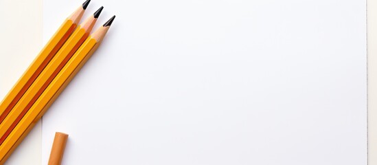 Poster - Two pencils and a piece of scrapbook paper on a white background creating a perfect copy space image