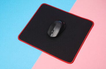 Wall Mural - Black PC mouse with PC mouse pad on a pink blue background