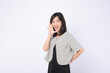 Asian woman is posing with a shouting gesture against a white background.