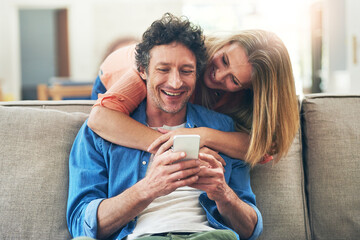 Poster - Mature, couple and hug on sofa with phone for reading online news, social media scroll and embrace in home. People, love and laughing with smartphone for funny meme, bingo or digital gaming on couch