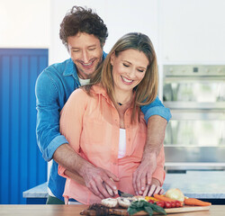 Sticker - Cooking, couple and food in a kitchen with hug, smile and happy from love and marriage. Vegetables, home and healthy eating with lunch, nutrition and knife in a house with meal and laugh with care