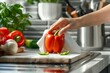 Woman wiping bell pepper with paper towel in kitchen, preparing for freezing, washing vegetables