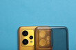 Yellow Smartphone with silicone protective case on blue background