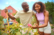 © Monkey Business - Teenage Daughter Helping Father With Gardening At Home Learning About Plants And Nature