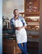 © peopleimages.com - Bakery, cafe and owner for business, portrait and smile for small scale restaurant and service. Kitchen, pastry and baker for entrepreneur in hospitality, shop and male person for food industry