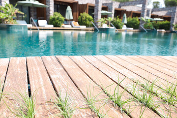 Wall Mural - Outdoor swimming pool with wooden deck at resort