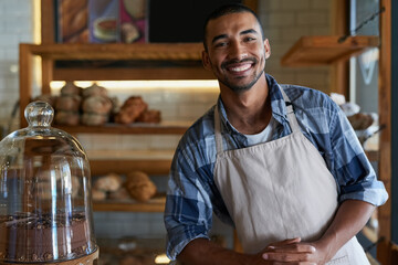 Bakery, cafe and male owner for business, portrait and smile for small scale restaurant and service. Kitchen, pastry and baker for entrepreneur in hospitality, shop and male person for food industry