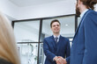 Successful businessmen handshaking after negotiation. Two smiling businessmen shaking hands while standing in an office. Business people shaking hands, finishing up a meeting
