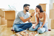 woman couple man box home house moving happy apartment together romantic relocation pizza eating