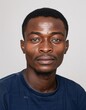 © Maelgoa - ID Photo for Passport : African young adult man with straight short black hair and blue eyes, thin mustache, without glasses and wearing a navy t-shirt