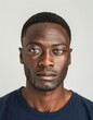 © Maelgoa - ID Photo for Passport : African adult man with straight short black hair and blue eyes, stubble, without glasses and wearing a navy t-shirt