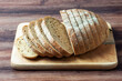 Loaf of multigrain bread on a wood tray