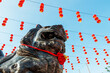 Close up of Chinese temple lion statue with red lantern