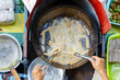 Deep frying Malaysian fried fish snacks called Keropok Lekor