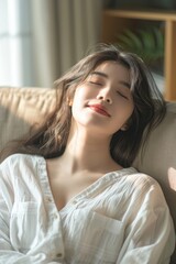 Aufkleber - A woman laying on a couch with her eyes closed. Suitable for relaxation and wellness concepts