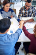 © peopleimages.com - Teamwork, designers or happy people with hands in stack for mission goal, collaboration or community. Graphs, partnership or staff in meeting for support, solidarity or group motivation in startup