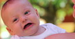 © Marco - Infant newborn baby changing emotions outdoors held by mom