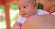 © Marco - Mother holding newborn baby infant outdoors cute infant face