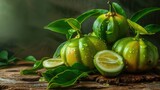 Close up of Fresh Garcinia Cambogia Fruit Dripped with Water Droplets on Green Background.
