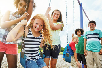 Portrait, children or kids in park outdoor playing together for friendship, bonding and relationship development. Happy, young people and swing on jungle gym for childhood fun or summer break